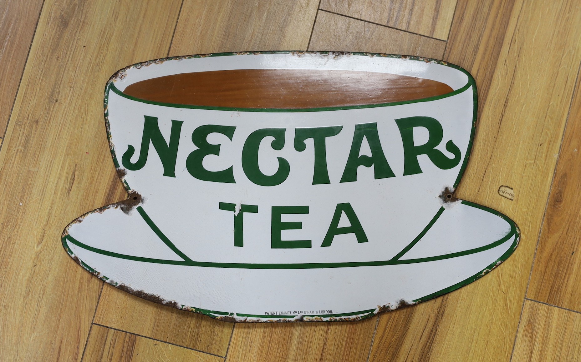 A Nectar Tea advertising enamel sign, in the form of a teacup and saucer, height 32 cms